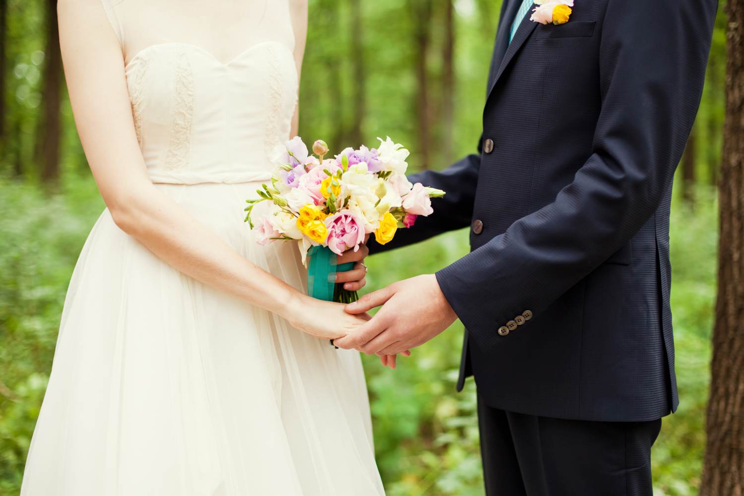 Couple holding hands on wedding day