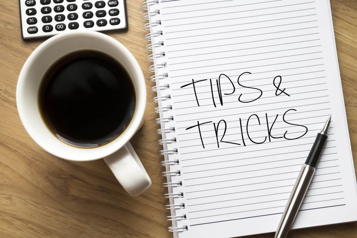 Tips and tricks for planning a corporate event - Tips and tricks written on notebook, cup of coffee on left side
