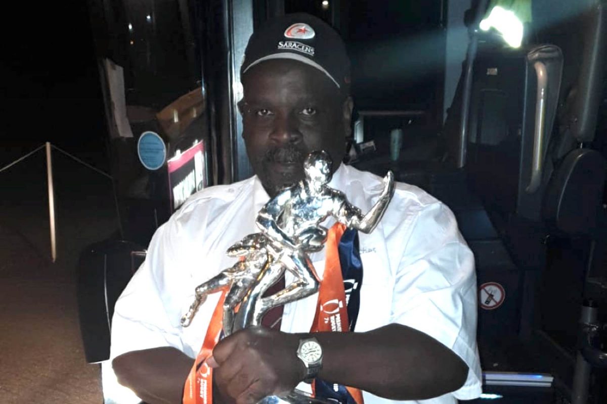 Saracens driver MET Coaches holding trophy